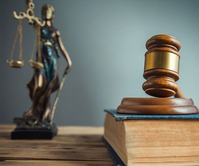 Justice scales and gavel on legal book representing Melbourne's criminal law.