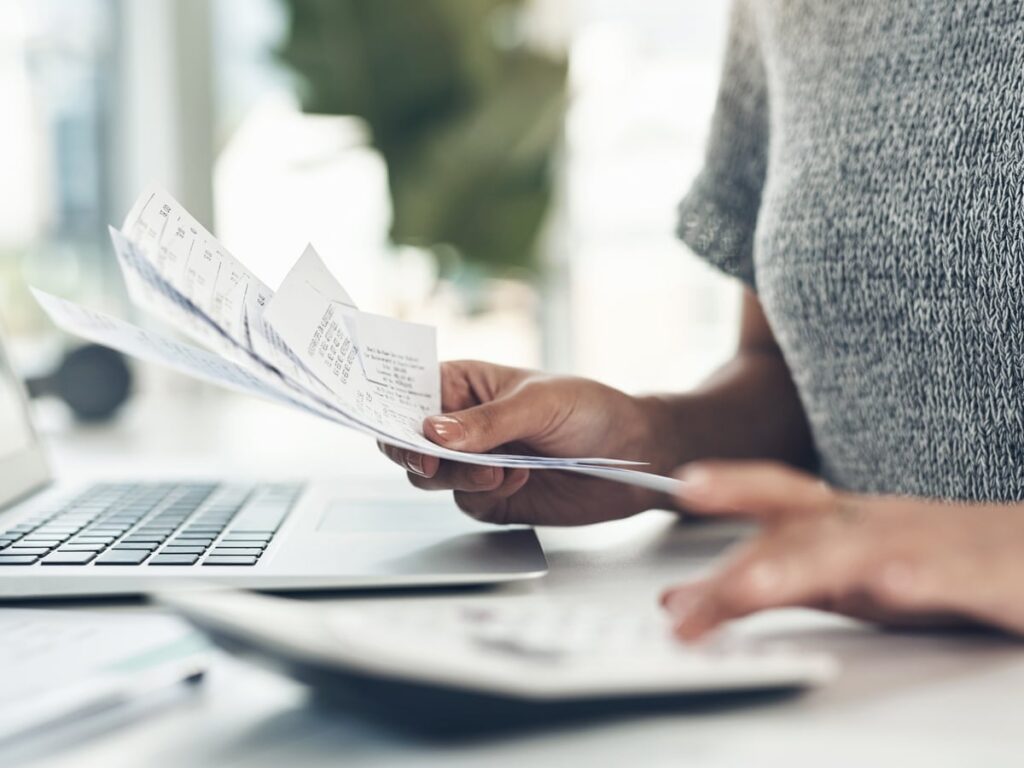 Business lawyer in Melbourne reviewing legal documents at a desk with a laptop.