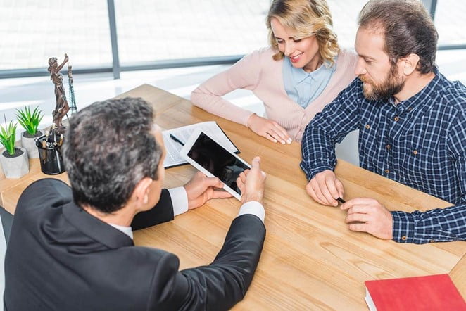 Overcoming The Challenges Of Contesting A Will In Victoria 3 Couple Consulting With A Lawyer Using A Tablet.