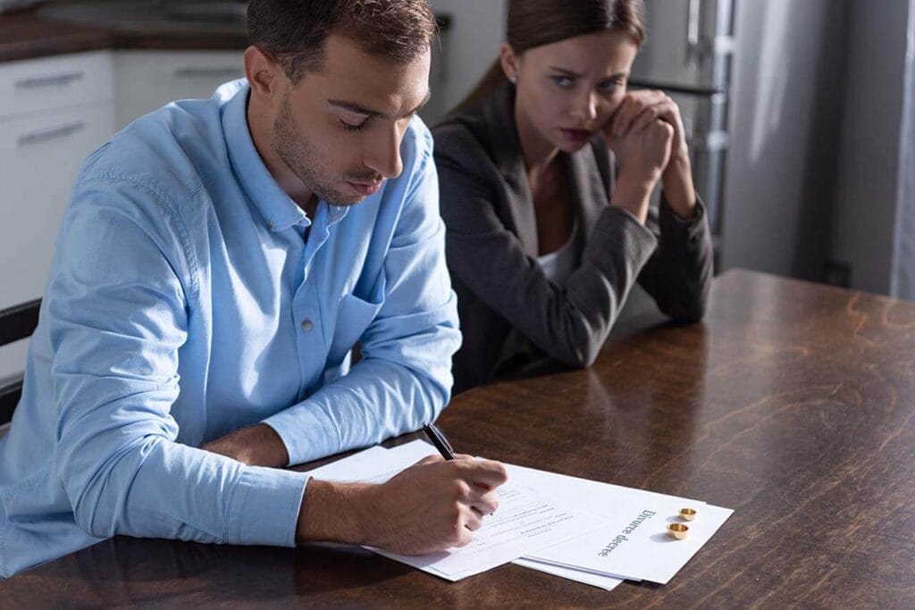 Navigating Property Settlements During Divorce: Your Essential Guide For Melbourne Residents 2 Melbourne Couple Signing Divorce Papers During Mediation.