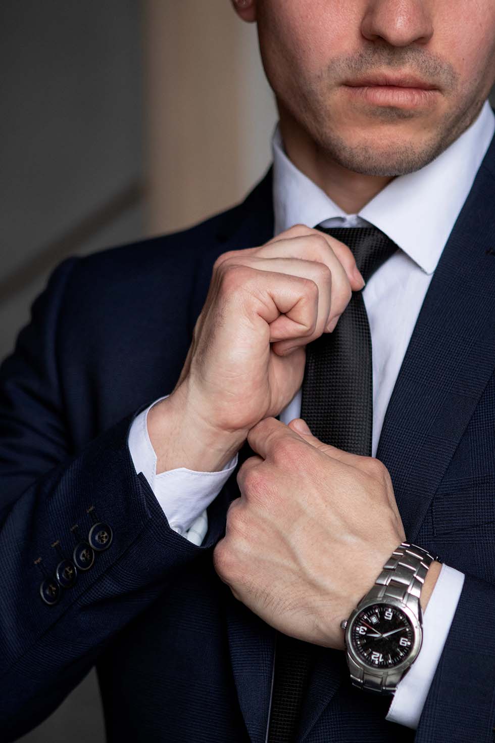 Commercial Lawyers Melbourne 5 Business Professional In A Suit Adjusting His Tie, Symbolising Confidence And Preparedness.