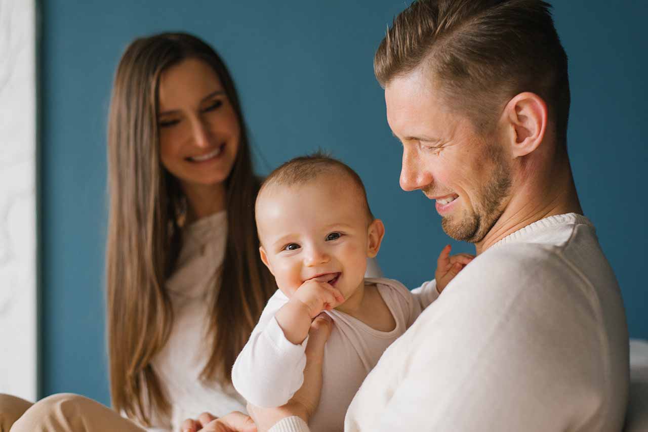Child Support 3 A Smiling Family With A Baby, Symbolising The Collaborative Process Of Developing Tailored Child Support Plans In Melbourne And Dandenong.
