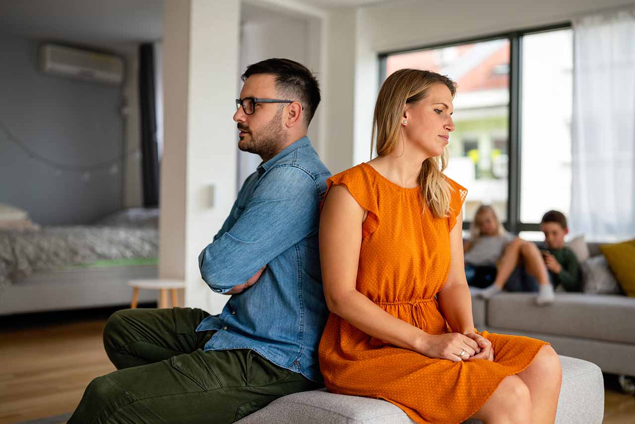 Binding Financial Agreements 8 A Couple Sitting Back-To-Back During A Separation, Symbolising The Importance Of Binding Financial Agreements For Asset Division In Melbourne.