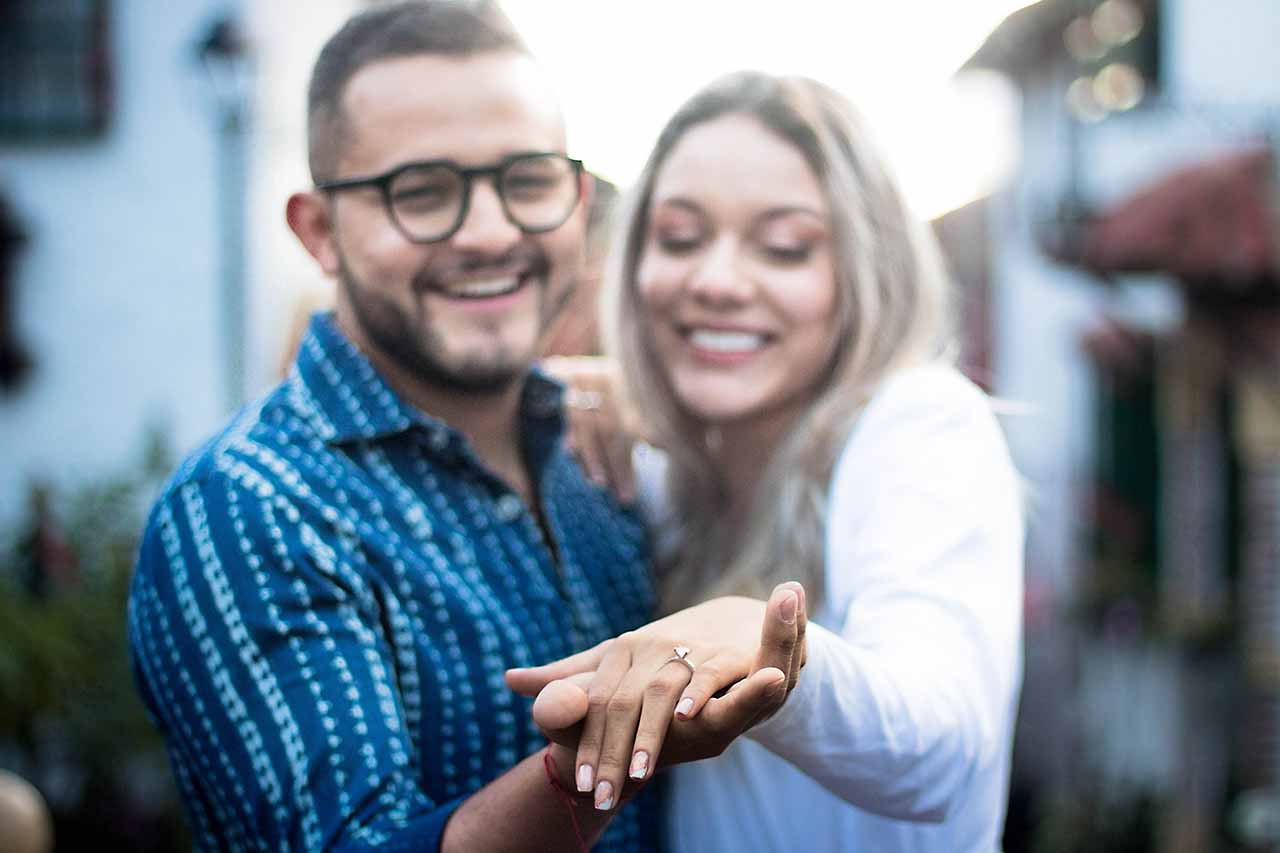 Binding Financial Agreements 7 A Happy Couple Showing An Engagement Ring, Symbolising The Importance Of Prenuptial And Postnuptial Agreements In Melbourne.