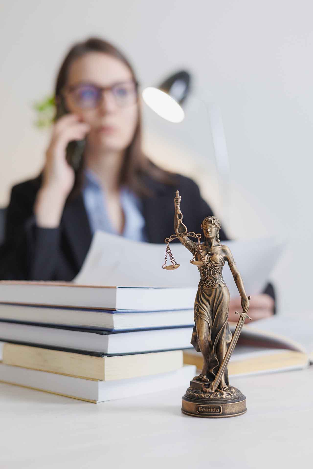 Transport Accident Injuries 1 Lawyer Consulting On A Transport Accident Case With Lady Justice Statue In The Foreground.
