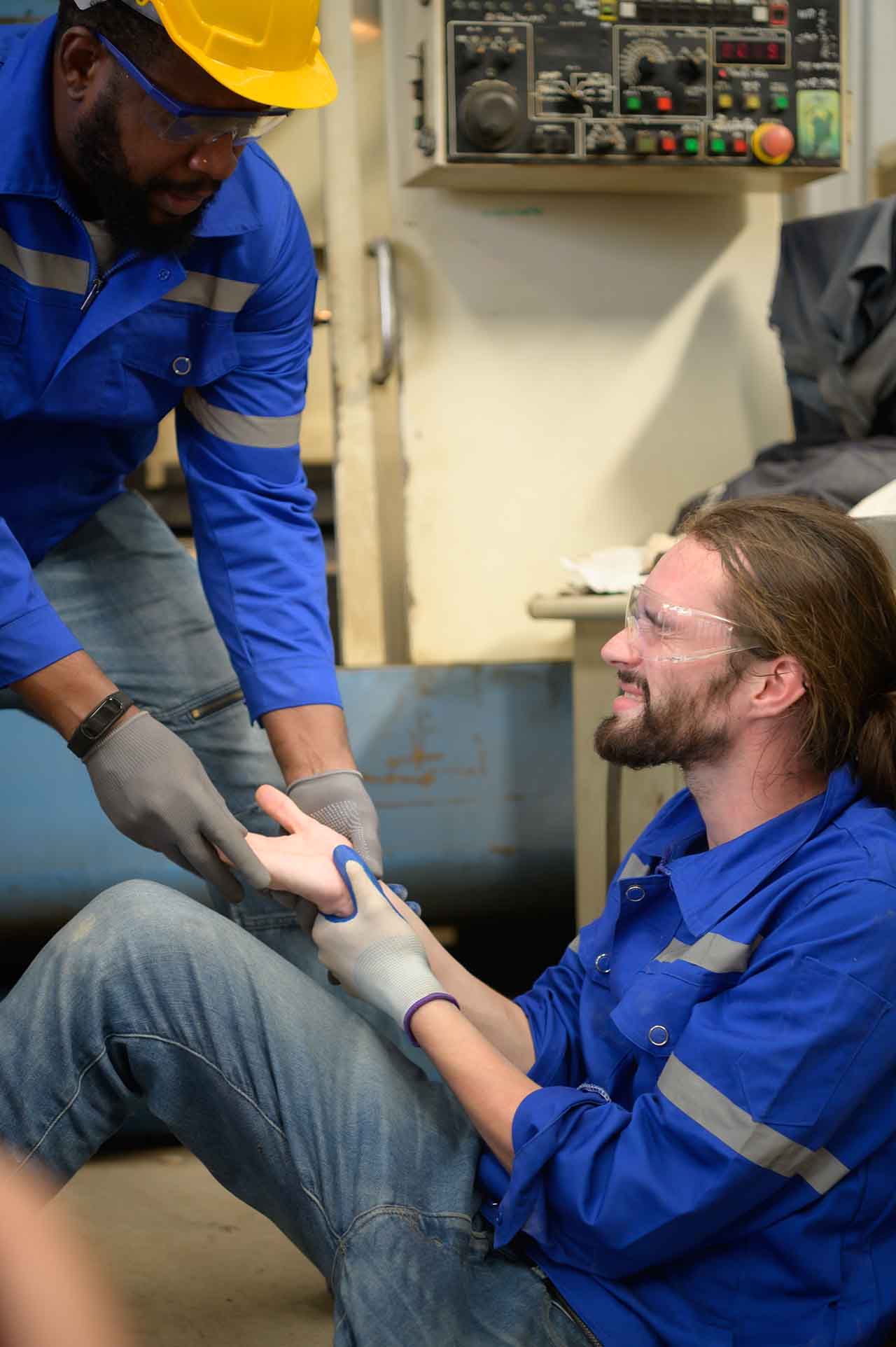 Work Injuries 1 Colleague Helping An Injured Worker With A Hand Injury At A Job Site.